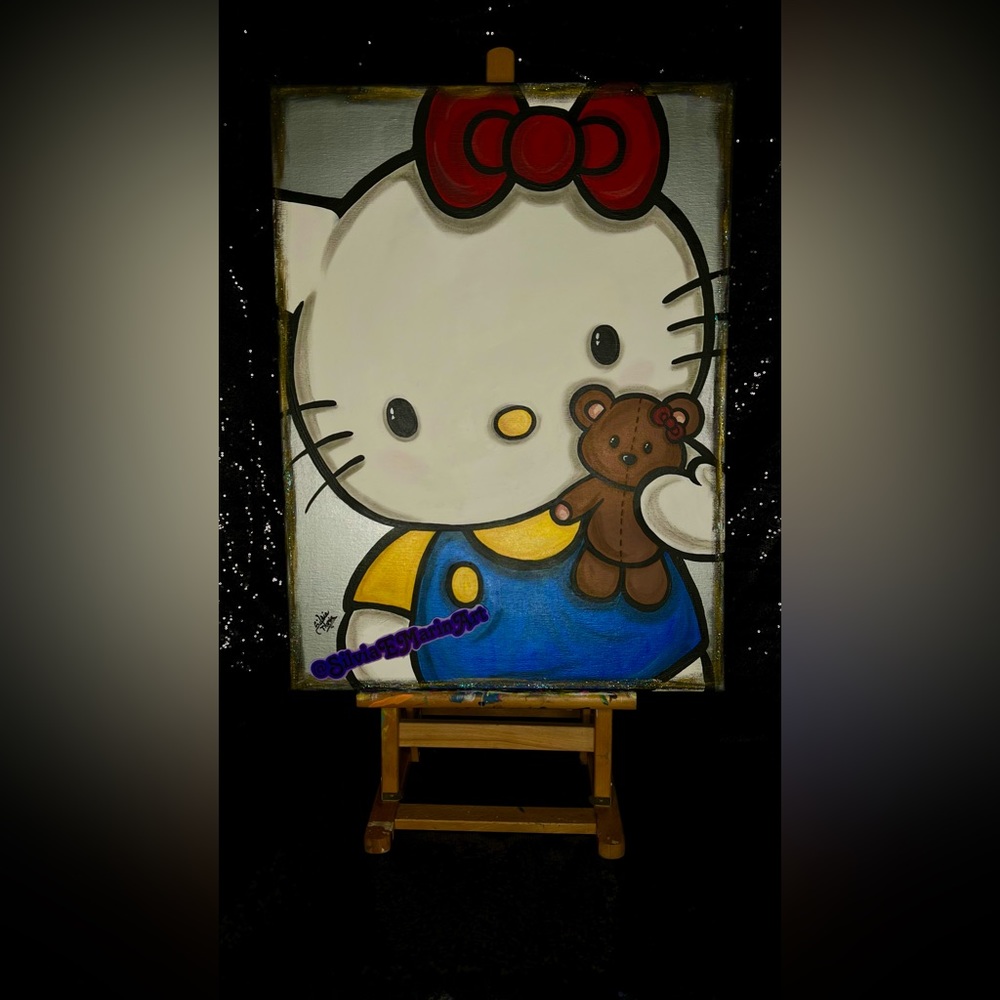 Hello Kitty holding a Teddy Bear